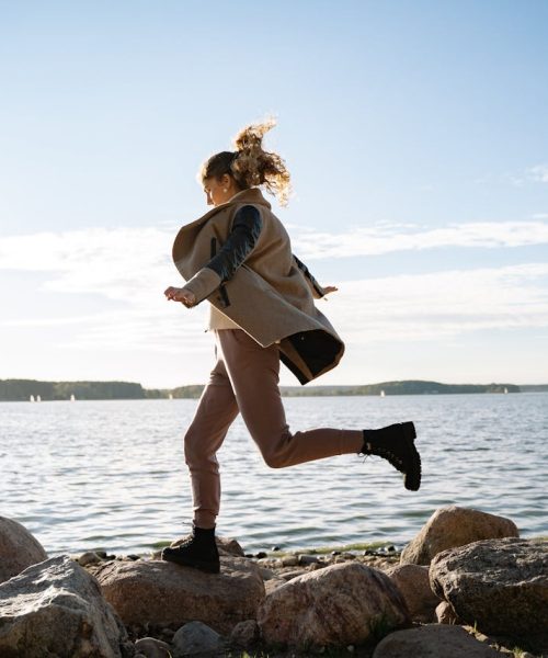 woman jumping on lake